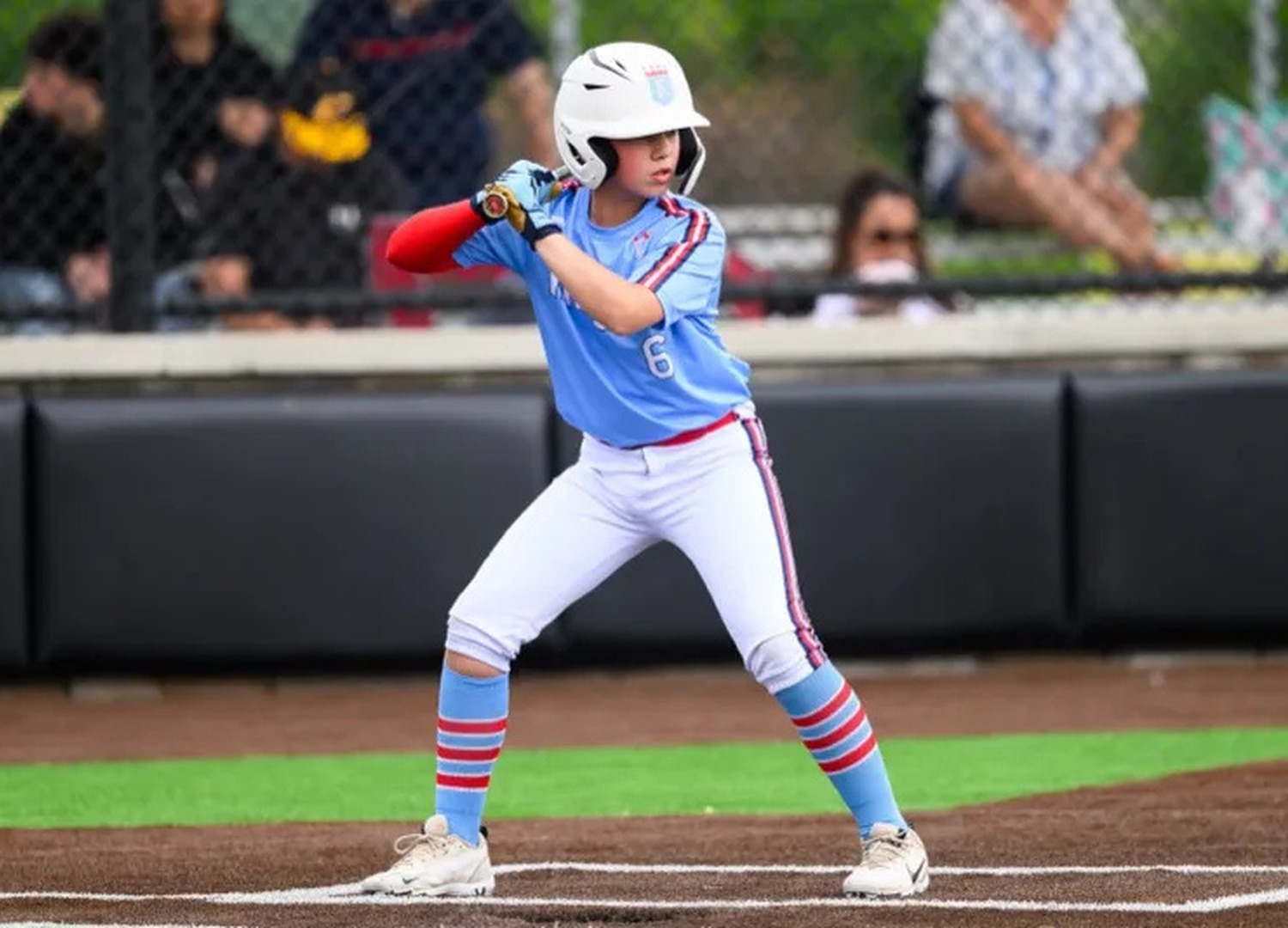 A high school softball player preparing to bat